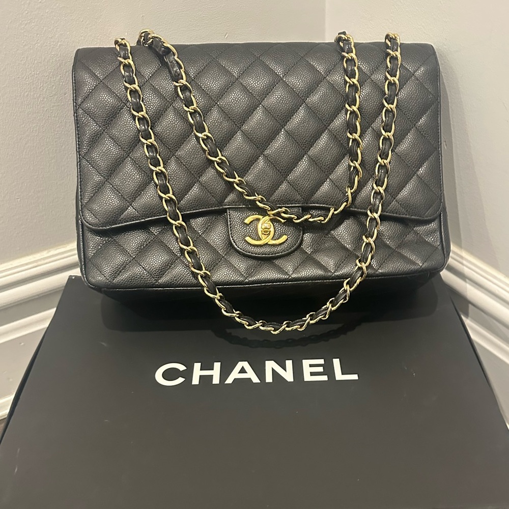CHANEL maxi classic flap bag in black caviar leather with gold hardware